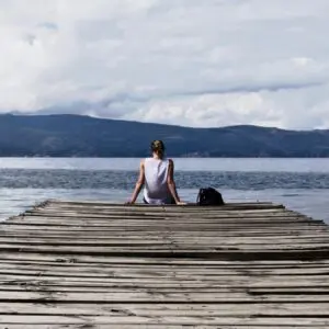 A person sitting on the harbor