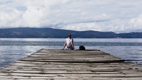 A person sitting on the harbor